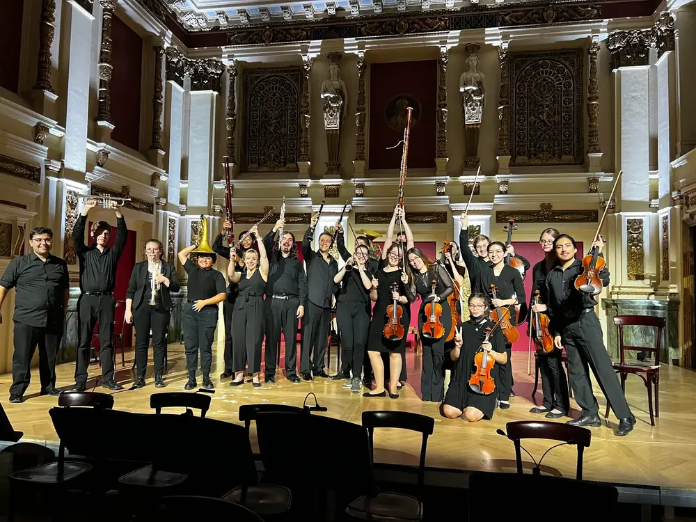 The festival orchestra and its conductors on stage after a concert